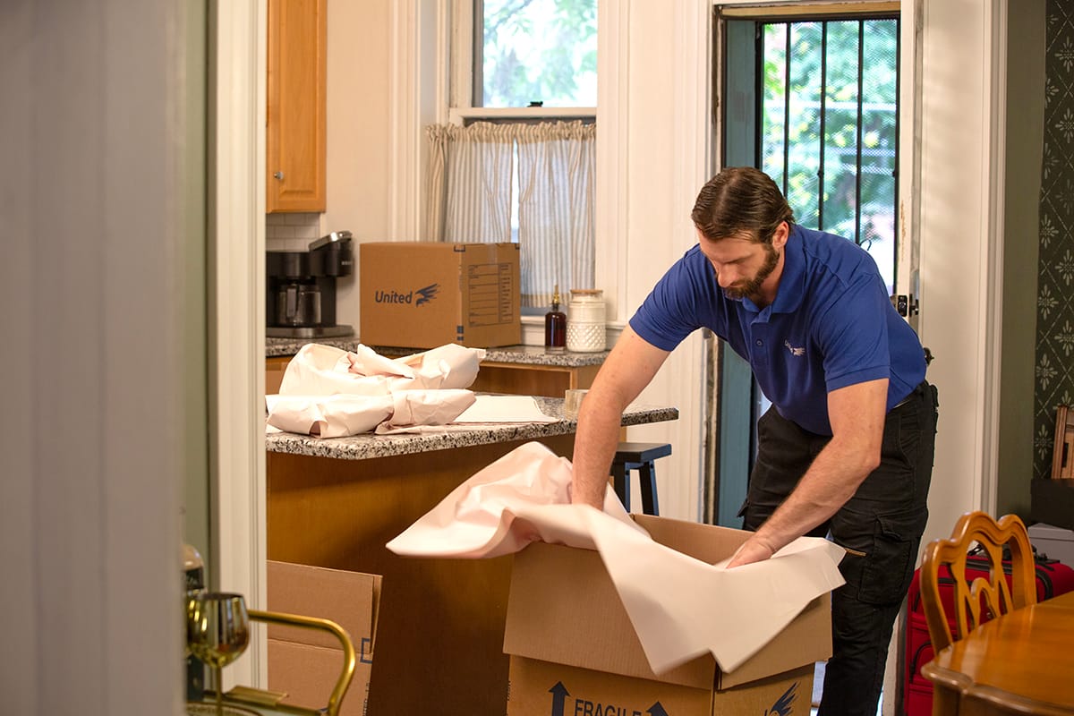 Team Member Boxing Dishware - Pro Tips for Moving in Madison, WI