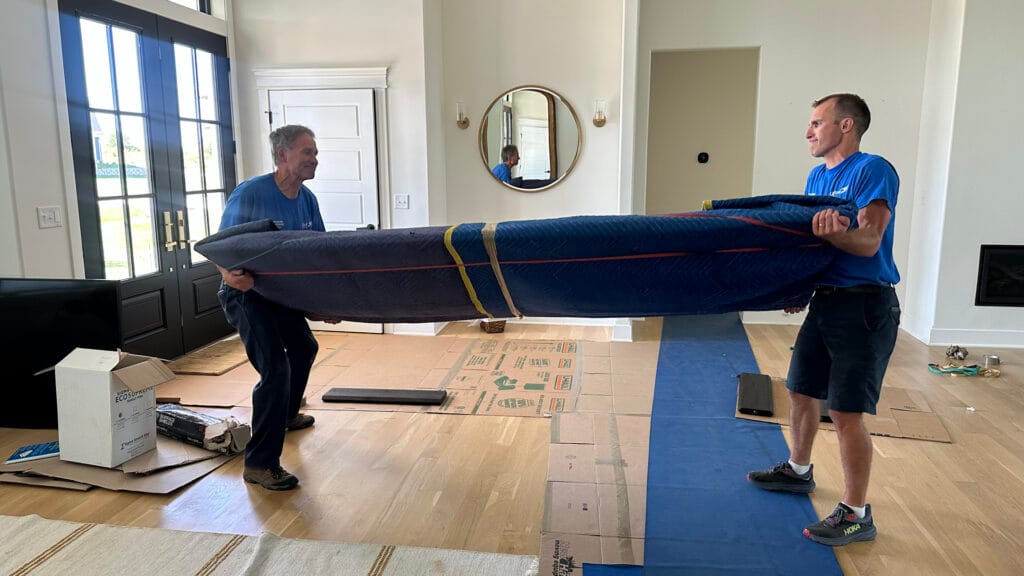 Two Christofferson packing and carry a sofa