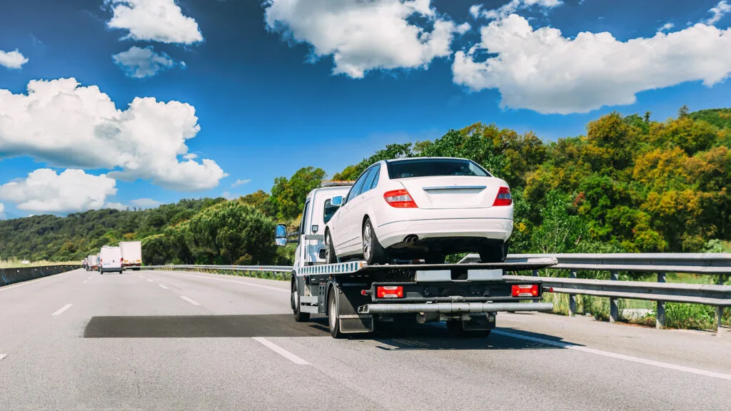Semi-Truck transporting automotive vehicle