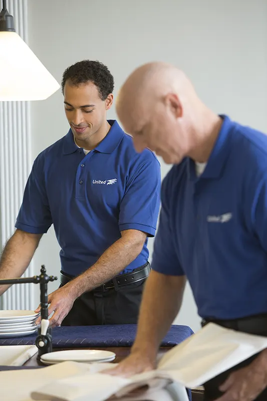 Christofferson employees backing fragile ceramic plates