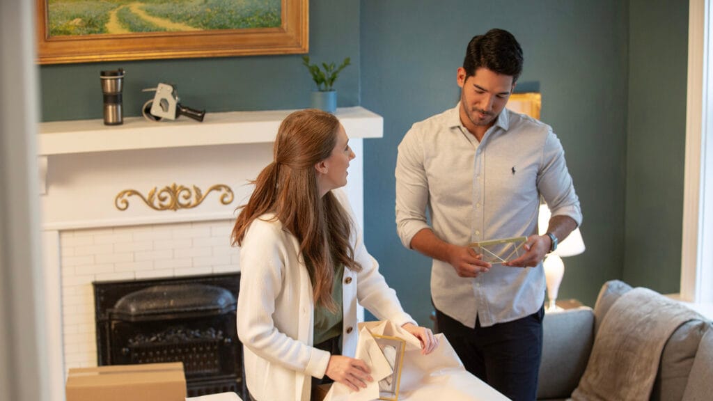 Young couple packing up a living room