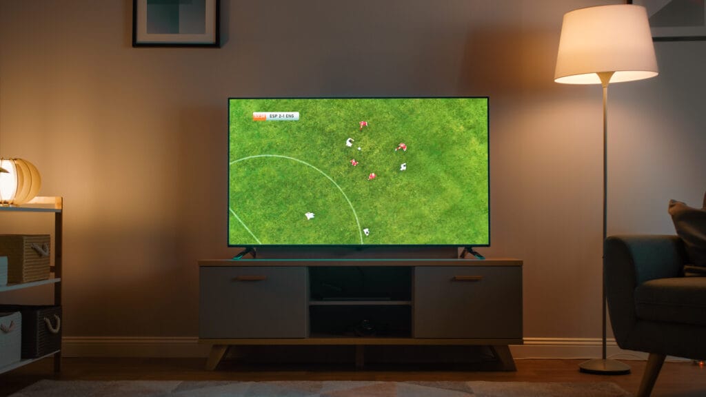 Shot of a living room with Television with a soccer match
