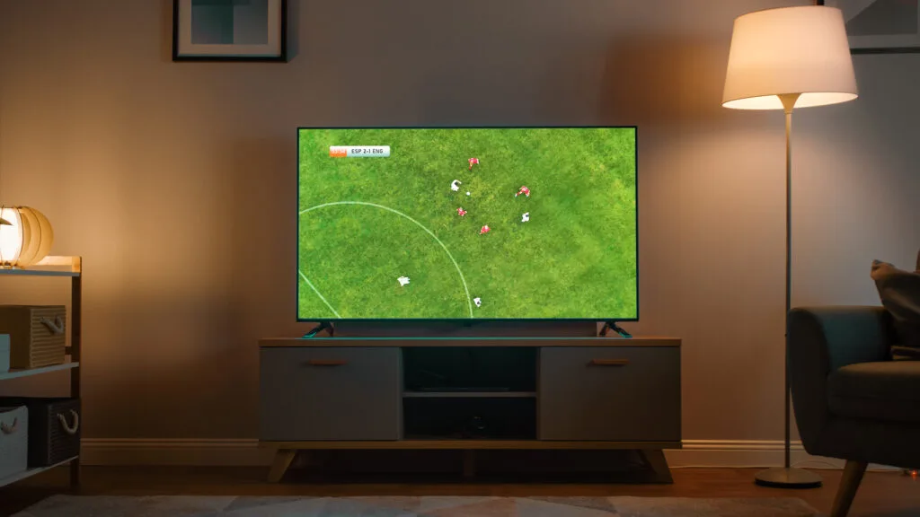 Shot of a living room with Television with a soccer match