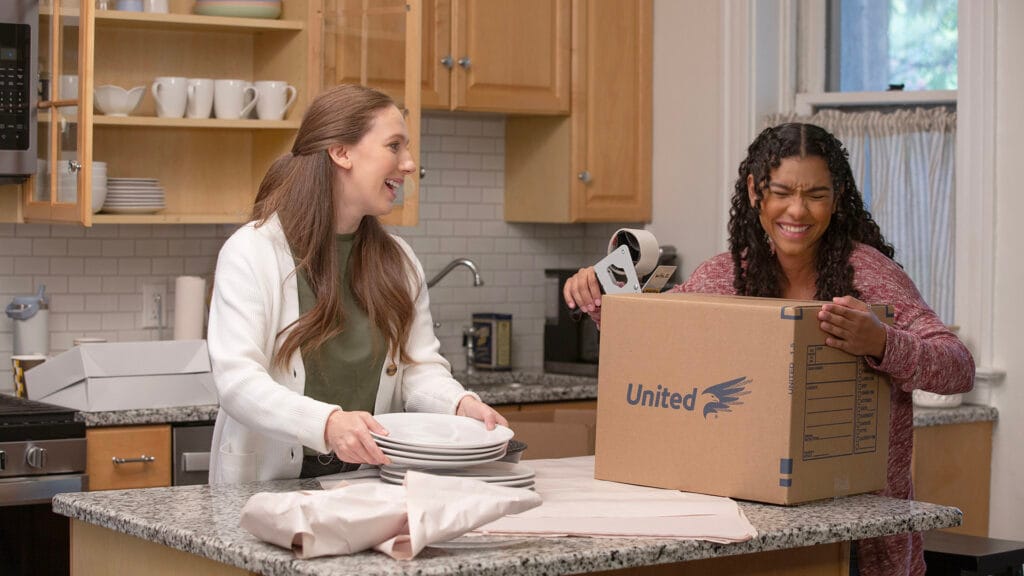 Group of friends packing up a kitchen