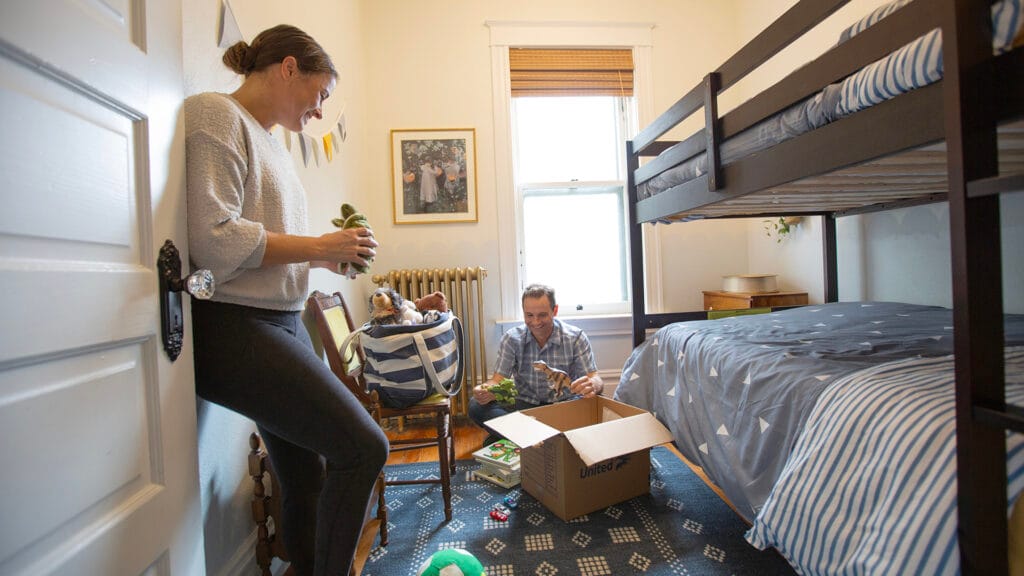 Couple boxing up a children's bedroom