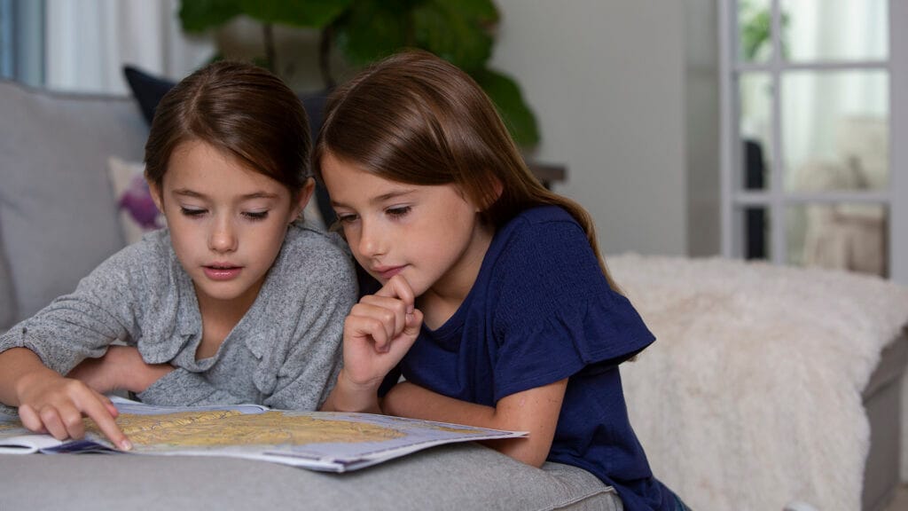 Two children view map of the united states