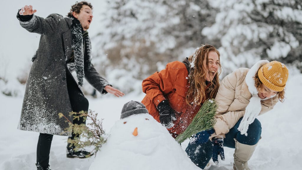 Group of friends playing in the snow