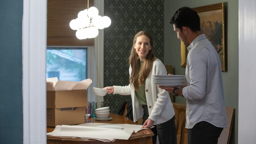 Young couple packing ceramic plates
