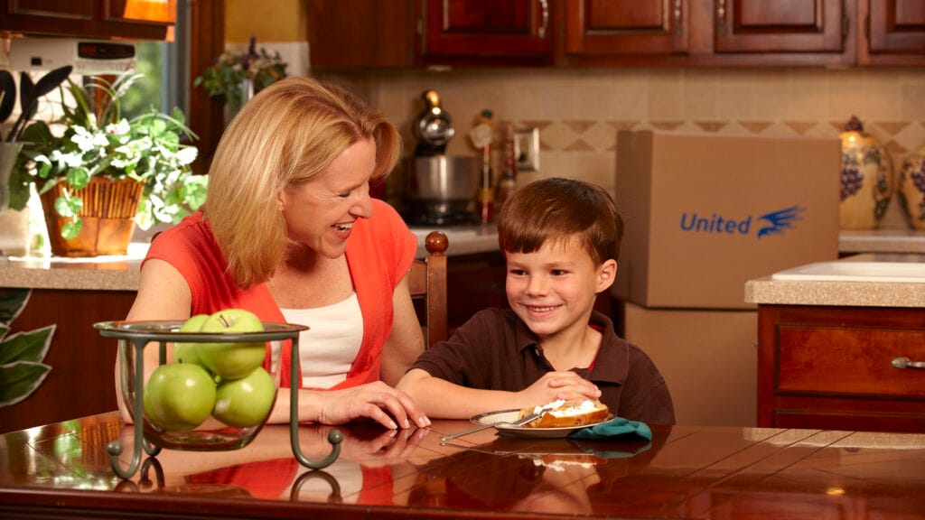 Mother and son eating toast in the kitchen
