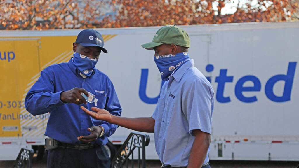 Christofferson employees sharing hand sanitizer
