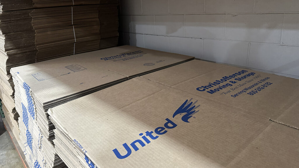 Stack of moving boxes branded with Christofferson logo